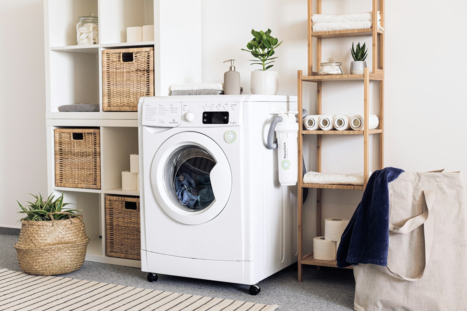 A clean, modern laundry room with a front-load washer