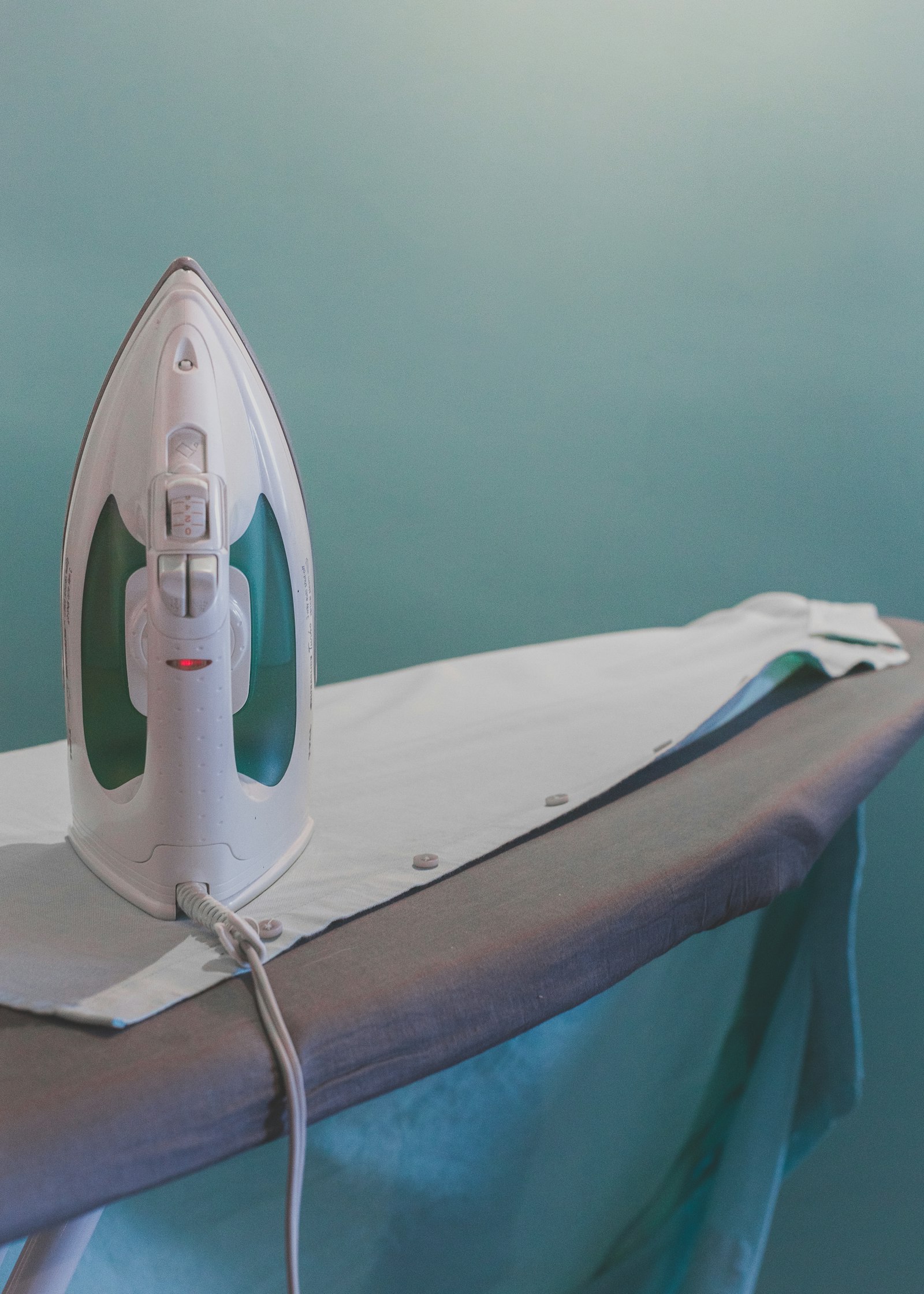 A steam iron pressing a freshly cleaned shirt